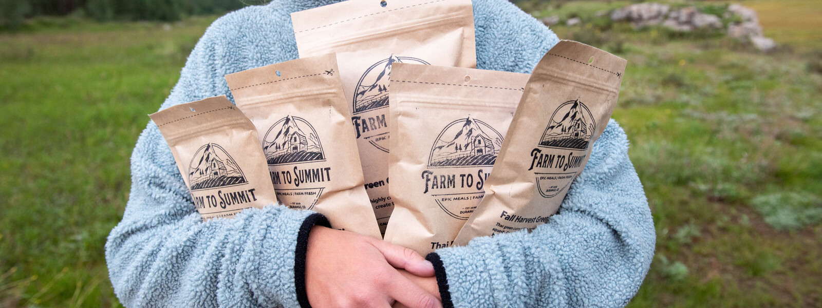 Owner holding farm to summit supplies