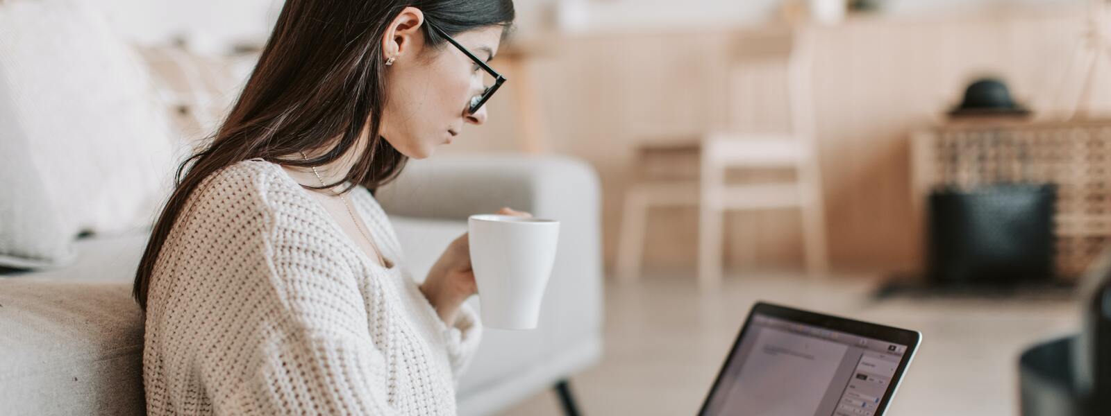 girl working at computer with coffee