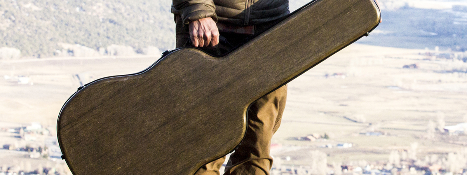 Man holding guitar case