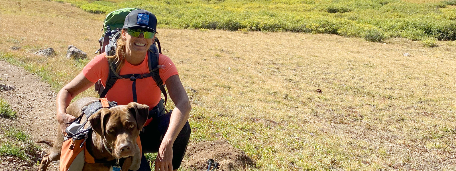 woman in field with dog